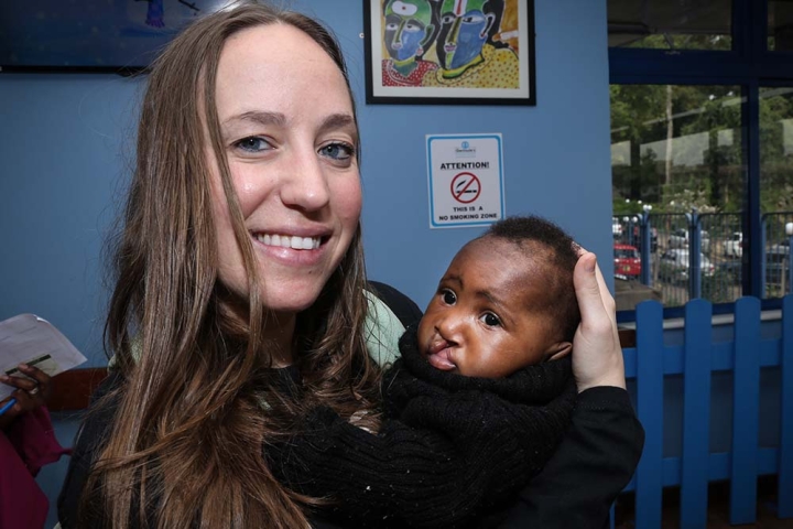 Jessica holds a baby