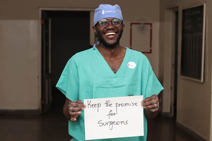 Surgeon holding up sign for social media campaign