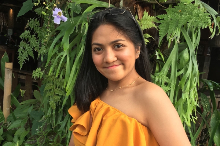 Julia smiling in front of some plants