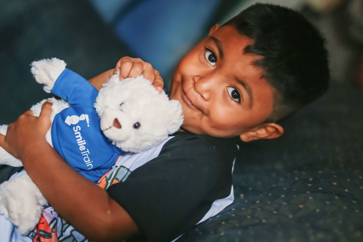 Mathias holding his Smile Train bears