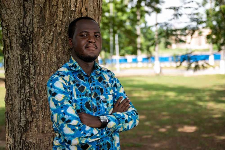 Kelvin leaning against a tree