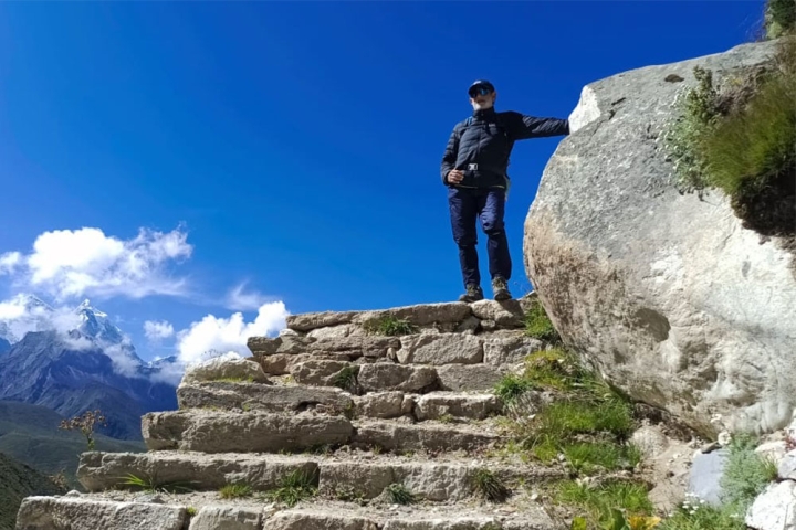 Sunil at the top of a stone staircase on the ascent to Everest Base Camp