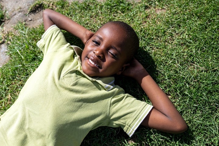 Wayne laying on the grass, looking at the sky