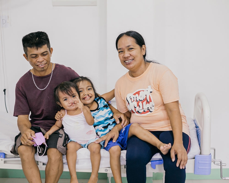 Ernie and Ermalen share a smile with their parents