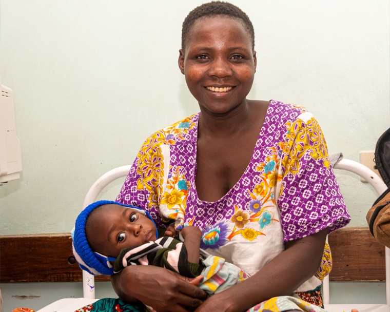 A Tanzanian mother smiling with her baby