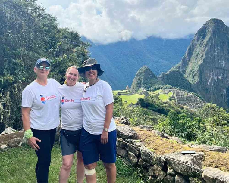 Sue Maughan smiling at Machu Picchu with her friends