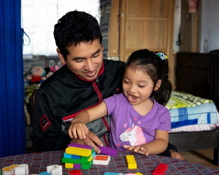 Itzayana building a block tower with her father Sandro after cleft surgery