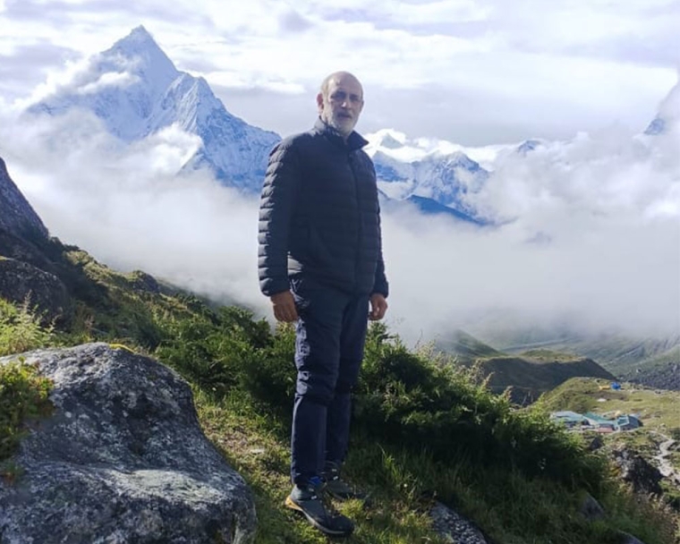 Sunil standing on a mountaintop