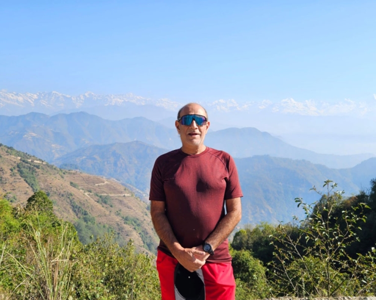 Sunil standing on a mountaintop