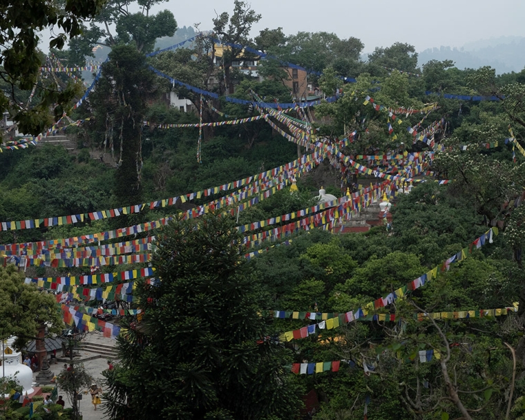 Tibetan prayer flags crisscrossing a mountain pass