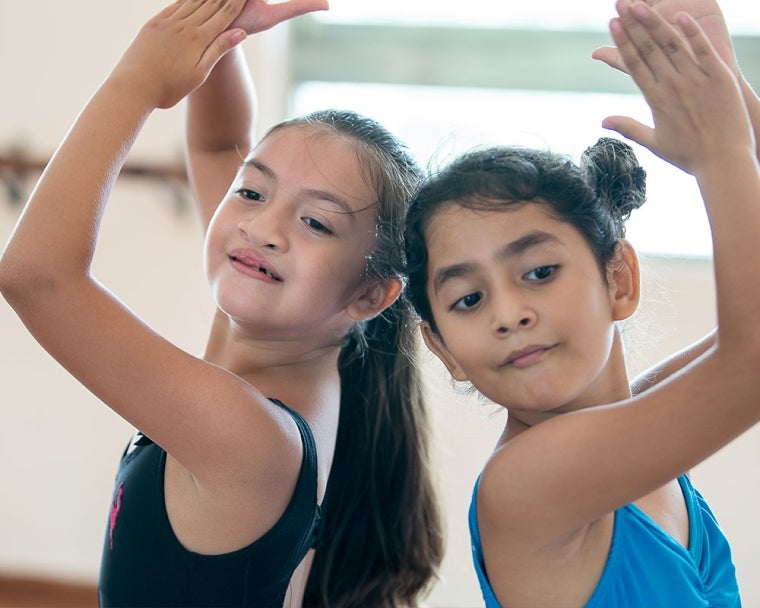 Aquetzaly doing a ballet move with another girl