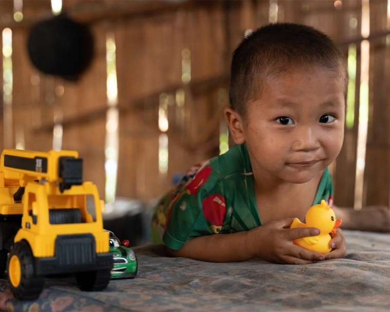 Jingtee smiling and playing with his toys after his cleft surgery