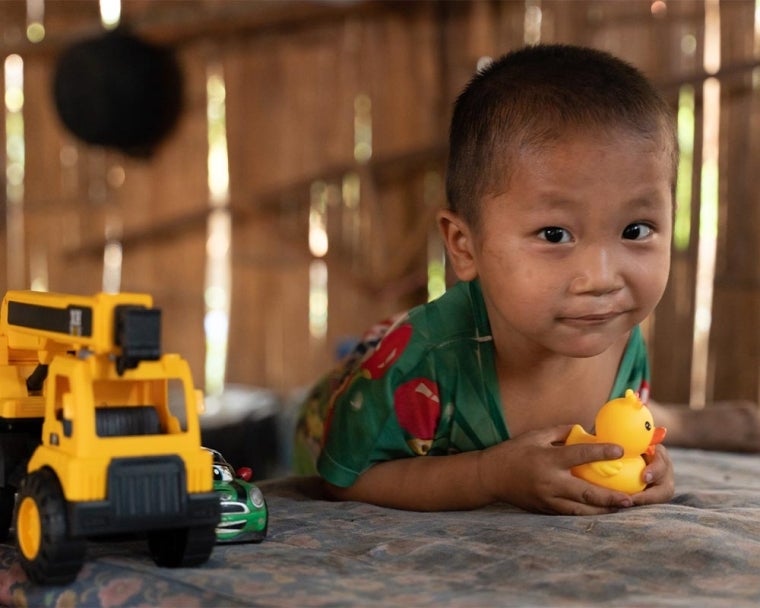 Jingtee smiling and playing with his toys after his cleft surgery