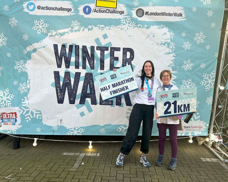 Emily Stott and her mother smiling and holding their medals at the Winter Walk Half-Marathon