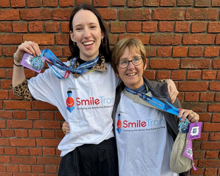 Emily Stott and her mother smiling, hugging and holding their medals